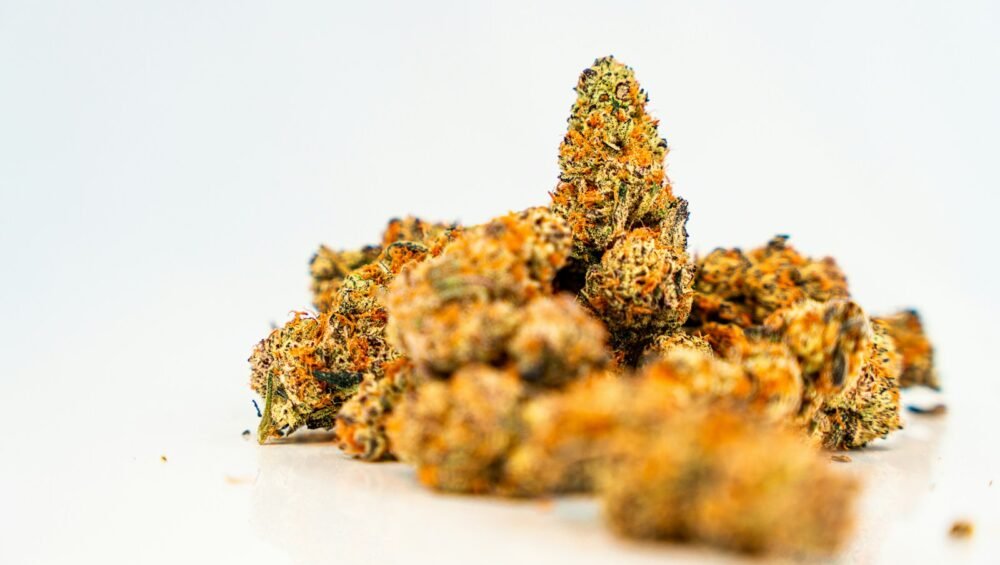 a pile of orange weed sitting on top of a white table