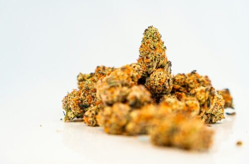 a pile of orange weed sitting on top of a white table